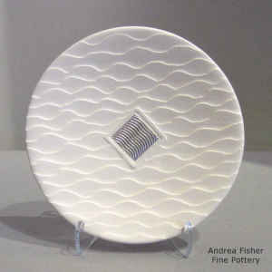 Shifting Sands surface on a white plate with a Shifting Sands sterling silver inlay