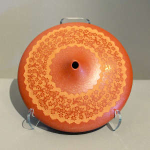 Sgraffito bird and floral design on a red seed