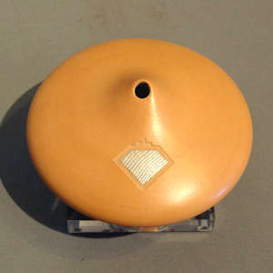 Shifting Sands sterling silver inlay on a tan flying saucer-shaped seed pot with an organic opening