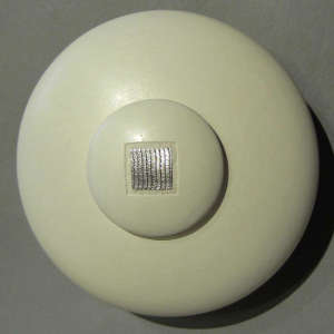 Inlaid silver on a lidded white seedpot