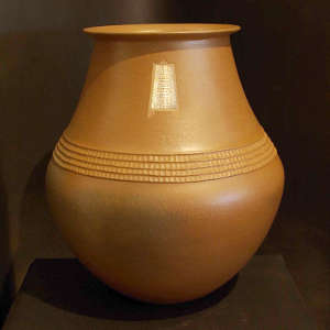 Three Shifting Sands sterling silver inlays on a golden micaceous jar with a band of corrugation around the shoulder