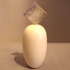 Sterling silver Shifting Sands design lid on a white seed pot