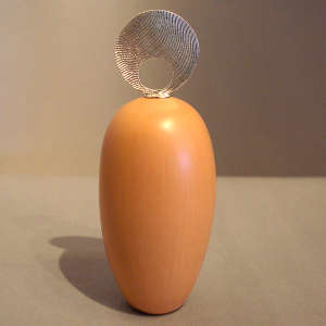 Round Shifting Sands-design sterling silver lid on a tan seed pot