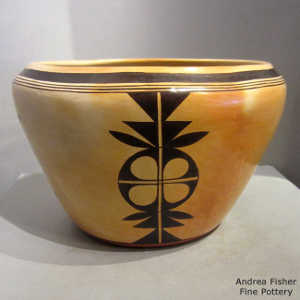 Black geometric design inside and out on a yellow ware bowl