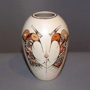 Stylized hummingbird and shard design on a polychrome white jar