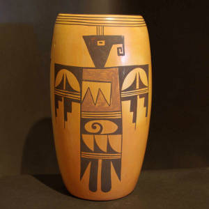 Red and black thunderbird design on a yellow ware cylinder