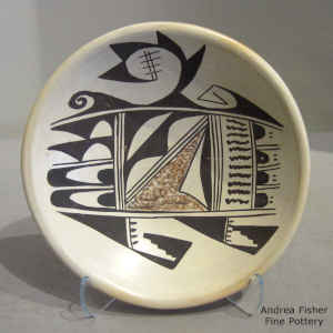 Bird element, fire clouds and geometric design on a yellowware plate