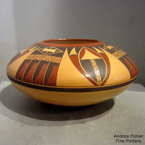 Stylized eagletail and geometric design on a polychrome yellow ware jar