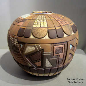 Feather and geometric design on a polychrome carved and painted seed pot