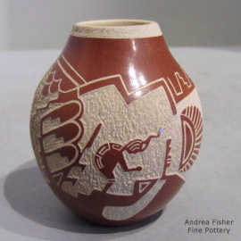 A sgraffito dancer, katsina and geometric design on a red jar