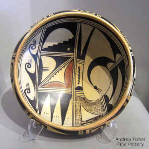 Polychrome bowl with fire clouds decorated with a bird element and geometric design inside, bat wing and geometric design outside