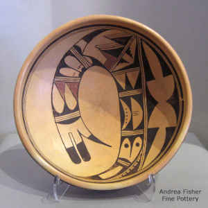 Bird element and geometric design inside with a geometric design outside decorate this polychrome bowl