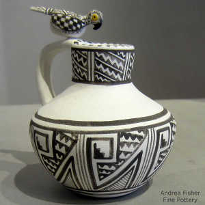 Polychrome roadrunner sits on the handle of a black and white jar with fine line, kiva step, rain, lightning bolt and geometric design