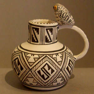 Geometric design and a polychrome owl on a black and white pitcher