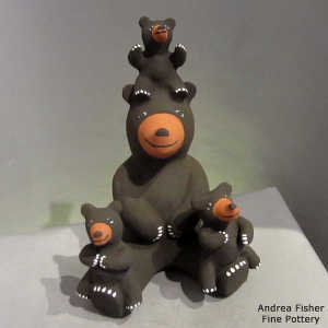 3 cubs on a brown bear figure