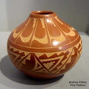 Sgraffito feather, kiva step and geometric design on a red jar