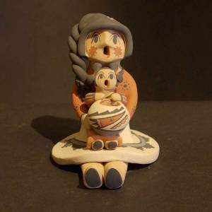 Braided hair, one child and a pot on a grandmother storyteller