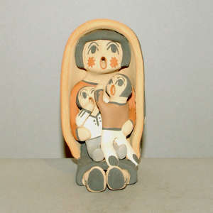 Two children on a grandmother storyteller in a manta