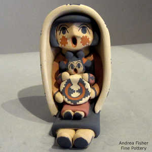 One child and a welcome basket on a grandmother storyteller in a manta