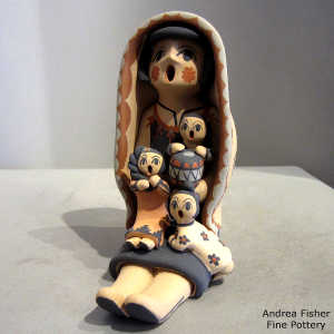 3 children and a drum on a grandmother storyteller in a manta