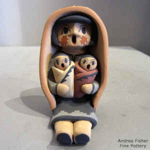 2 children and on a grandmother storyteller wearing a manta