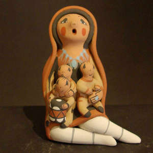 Three children and a drum on a storyteller in a manta