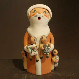 Four children bearing gifts and a drum on a Santa Claus storyteller