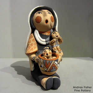 2 children and a pot on a grandmother storyteller in a manta
