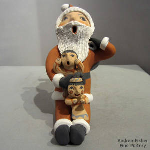 Two children and a shoulder sack on a Santa Claus storyteller