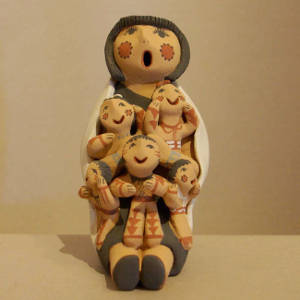 A blanket and five children on a grandmother storyteller