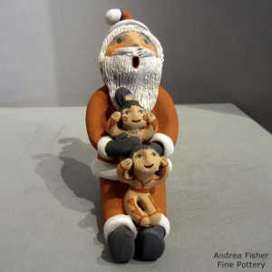 2 children on a Santa Claus storyteller