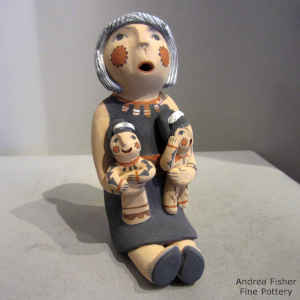 2 children and a pot on a grandmother storyteller