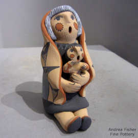 1 child on a grandmother storyteller wearing a manta