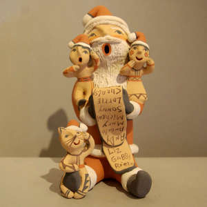 Two children and a cat on a Santa Claus storyteller