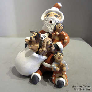 2 children and 3 puppies on a Santa Claus storyteller