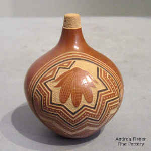 A sgraffito and painted ears of corn and geometric design decorated this miniature polychrome seed pot
