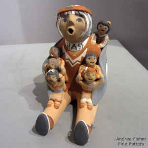 Six children on a sitting grandfather storyteller