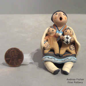 2 children on a miniature grandmother storyteller