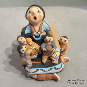 4 children on a miniature grandmother storyteller