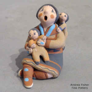 2 children on a miniature grandmother storyteller