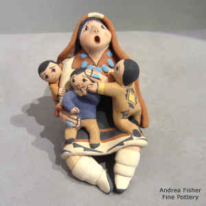 3 children on a miniature grandmother storyteller in a manta