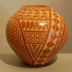 Sgraffito geometric design on a red jar