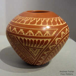 Sgraffito geometric design on a red jar