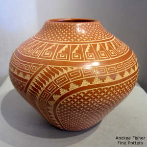 Sgraffito feather, spiral, kiva step and geometric design on a polished red jar