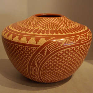 Geometric sgraffito designs on a red jar