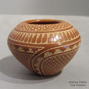 Sgraffito geometric design on a polished red jar