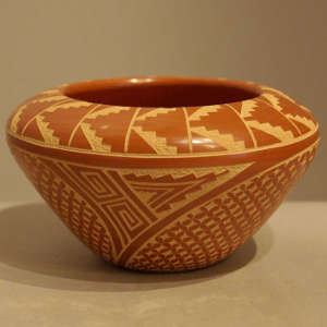 Sgraffito geometric design on a polished red jar