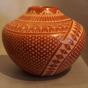Sgraffito kiva step, feather and geometric design on a polished red jar