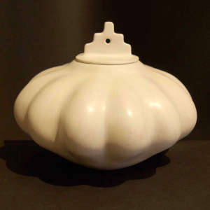 Kiva step lid on a white melon jar