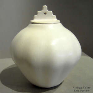 Lid styled after Laguna Pueblo Mission on a white melon jar